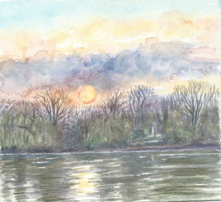 sunrise with bright sun and mauve cloud over the river